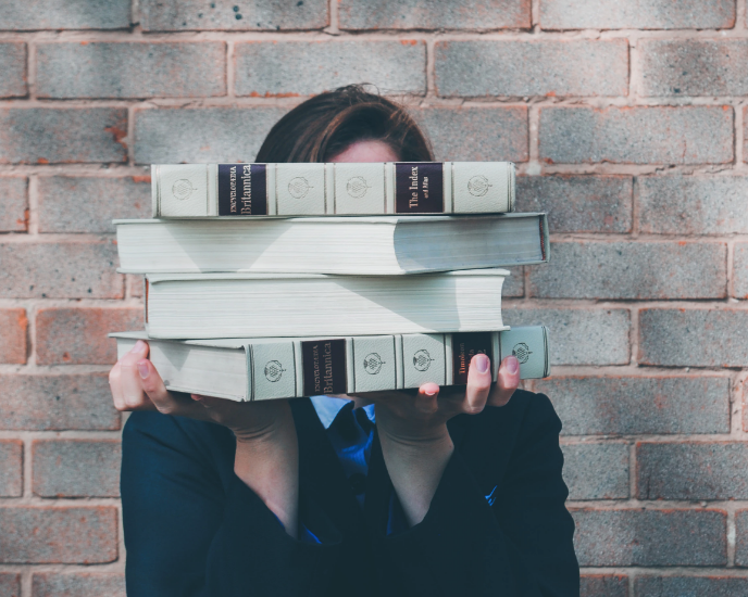 person holding the index, large books